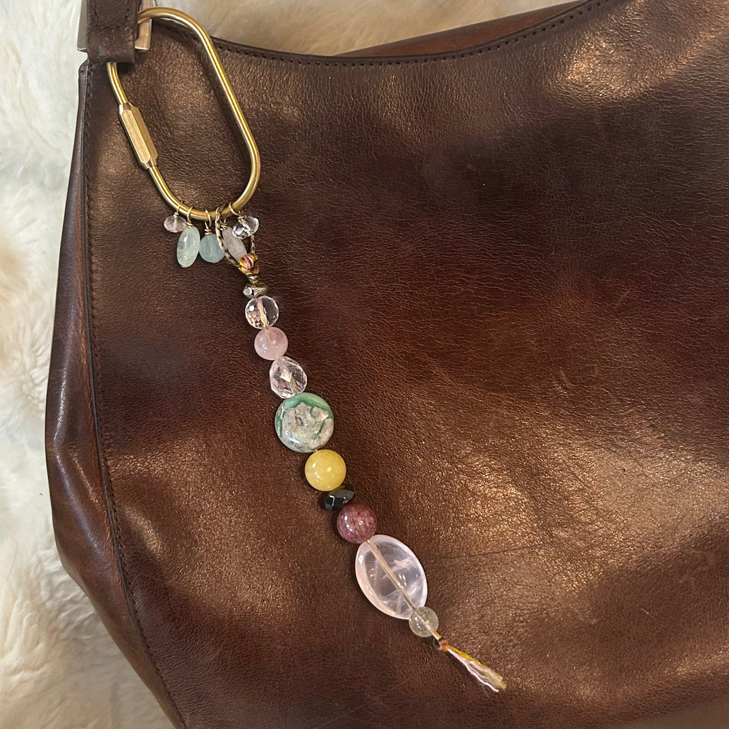 Bag adorned with radiant gemstone talisman bag charm