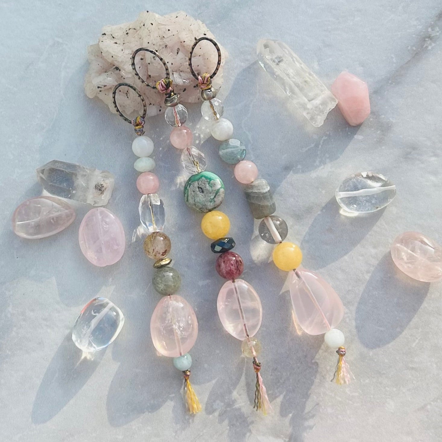 Handmade rose quartz charm with brass detailing for self love.