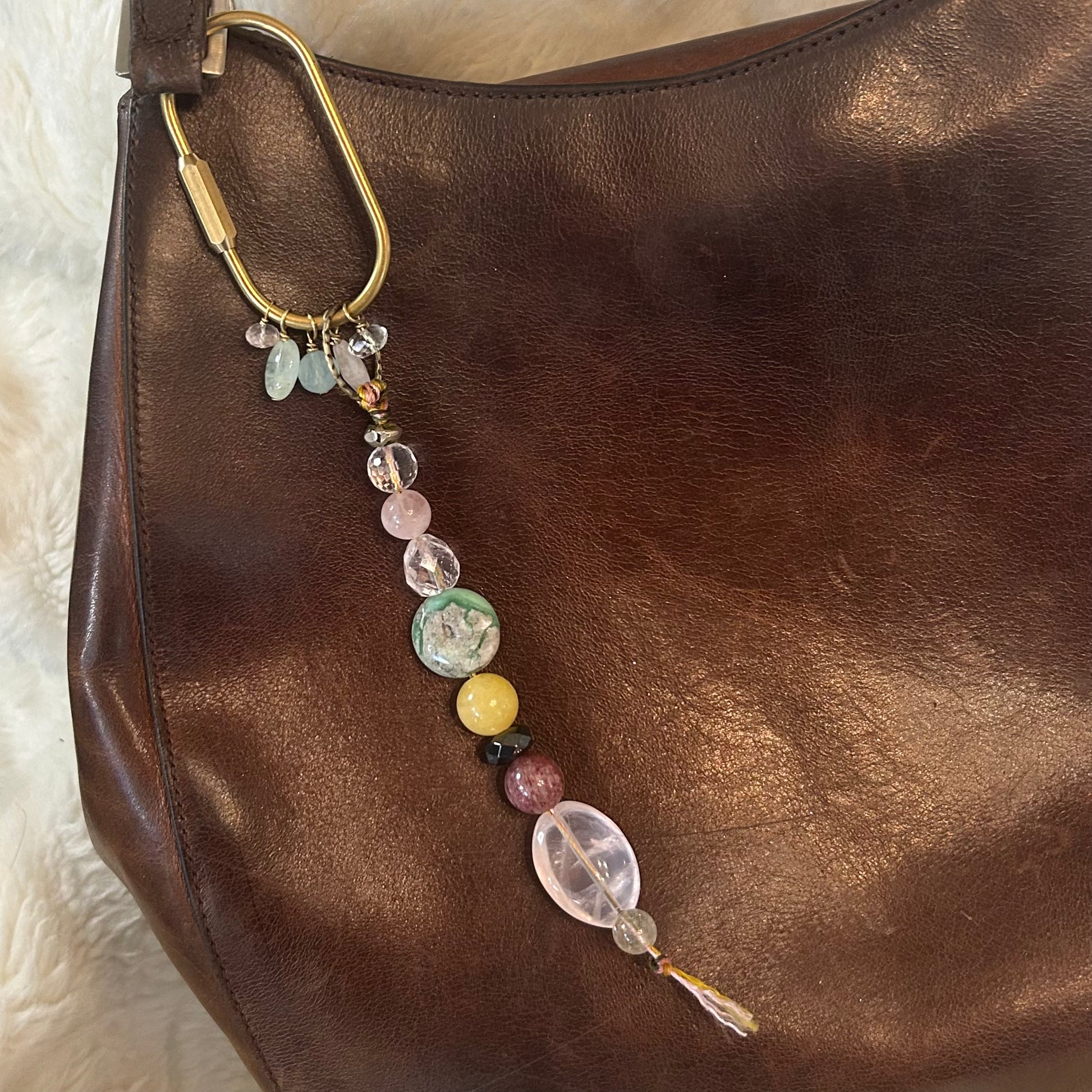 Bag adorned with radiant gemstone talisman bag charm