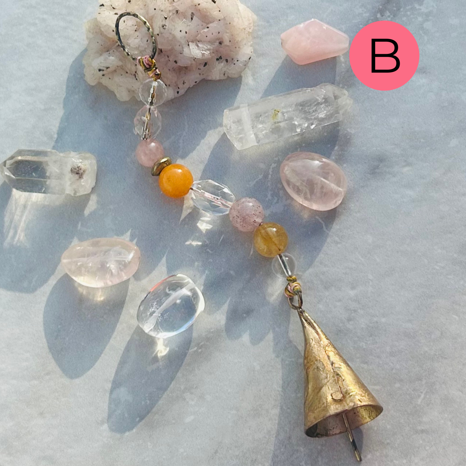 Gemstone accented brass bell talisman with soft chime